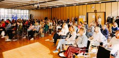Teilnehmende Ausverkaufter Saal mit gebannten Zuhörer*innen